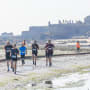 People running on a beach