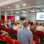 People sit and listen to a presentation