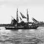 A black and white photo of a ship in the water.