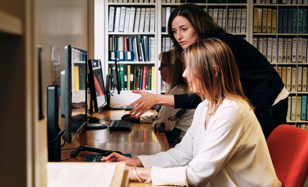 Jersey Archive Member of staff helps person on computer