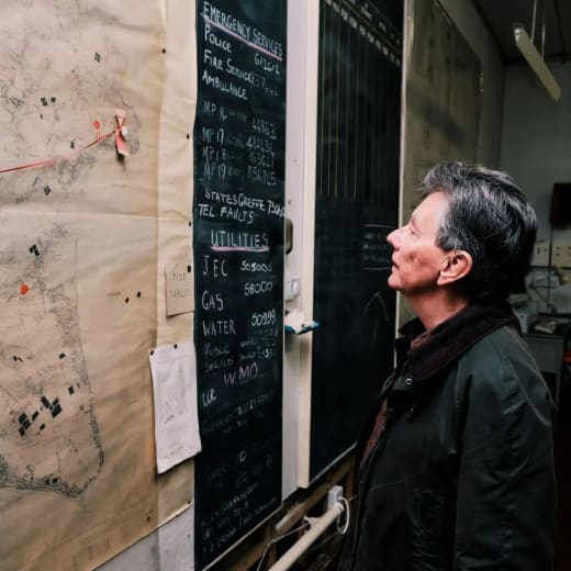 Cold War Bunker Man looks at large map on wall