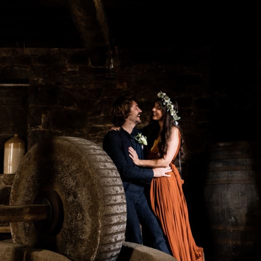 Hamptonne man and women embrace in cider barn