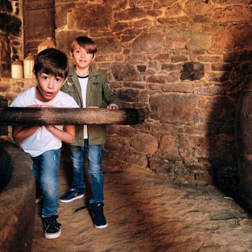 Hamptonne two children push the apple chrusher