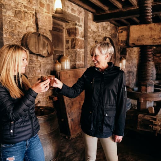 Hamptonne two women cheers in cider barn