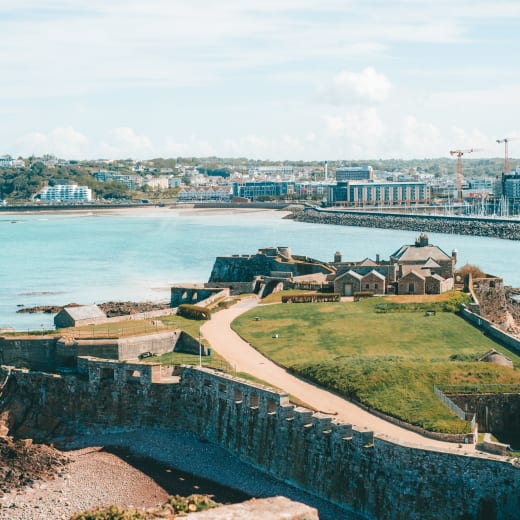 View across a large open green out to sea