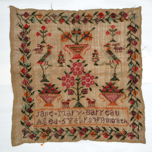 A sampler showing a colourful floral scene