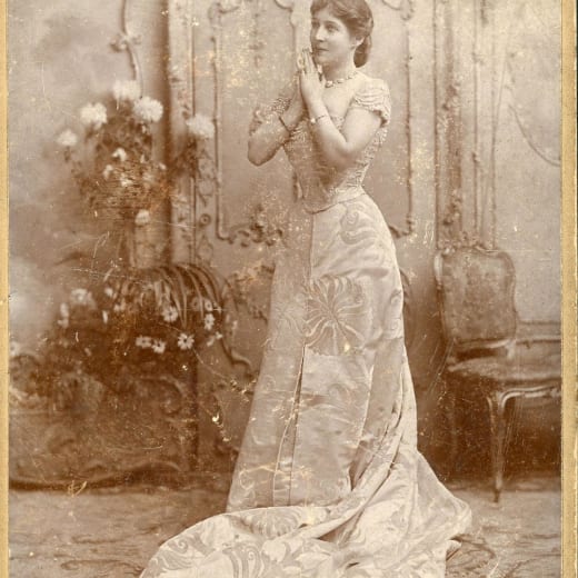 Black and white photo of a women dressed in an Edwardian style dress