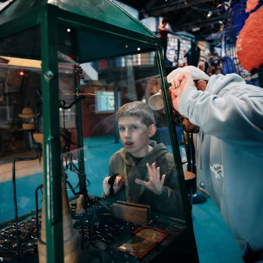 Boy and father play with exhibit