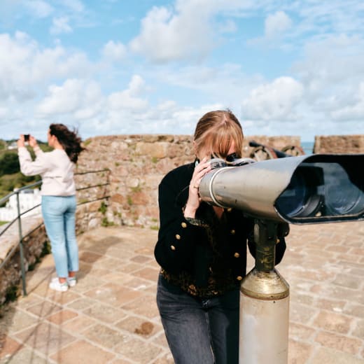 Mont Orgueil Castle girl looks through binoculars