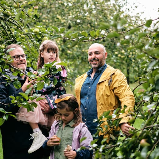 Young family in a green orchard