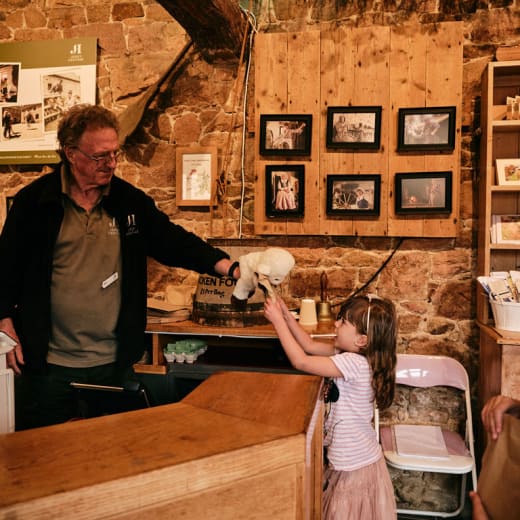 Young child talks to man at ticket desk