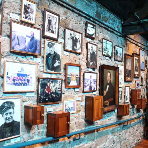 A wall with lots of framed photographs