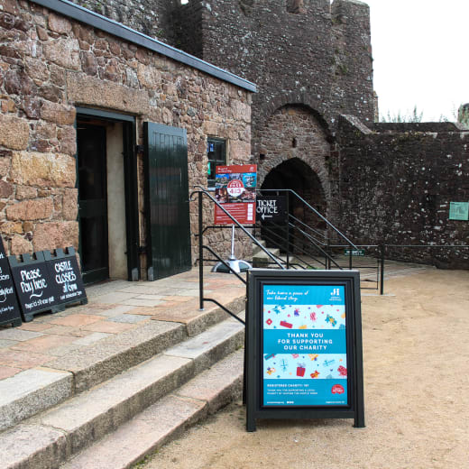 Entrance to a castle with posters and signage