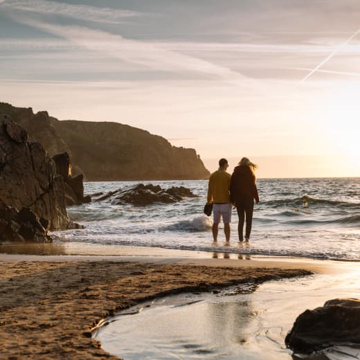 Couple walking on a sunset beach