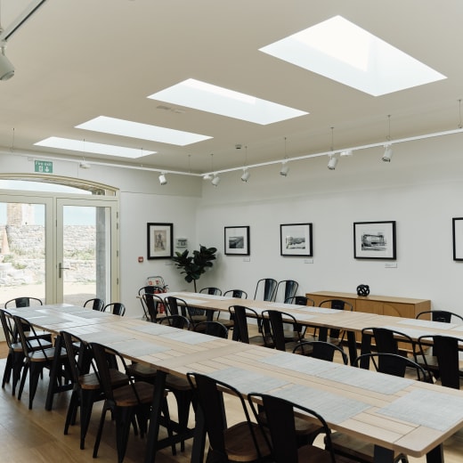 Table and chairs set up in a white room