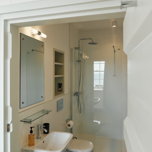 A white bathroom with shower