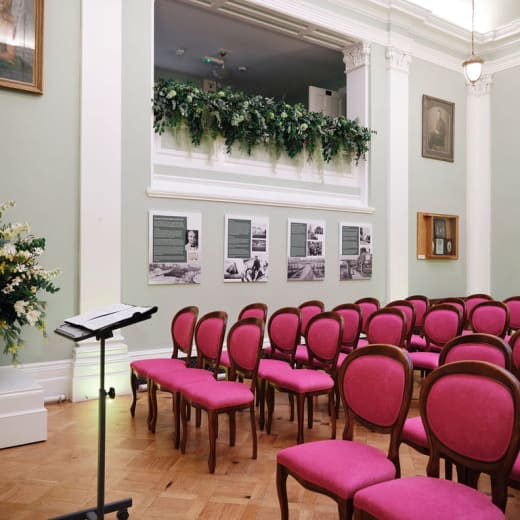 Red seating in a white room