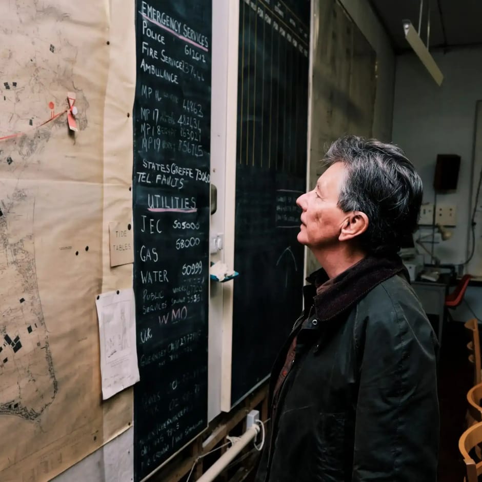Cold War Bunker Man looks at large map on wall