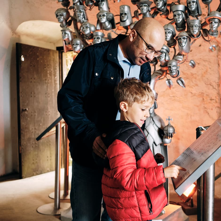 Mont Orgueil Castle father and son look at an exhibit