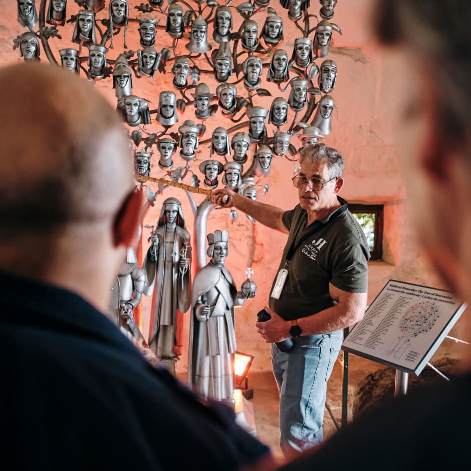 Mont Orgueil Castle volunteer shows off Tree of Succession exhibit
