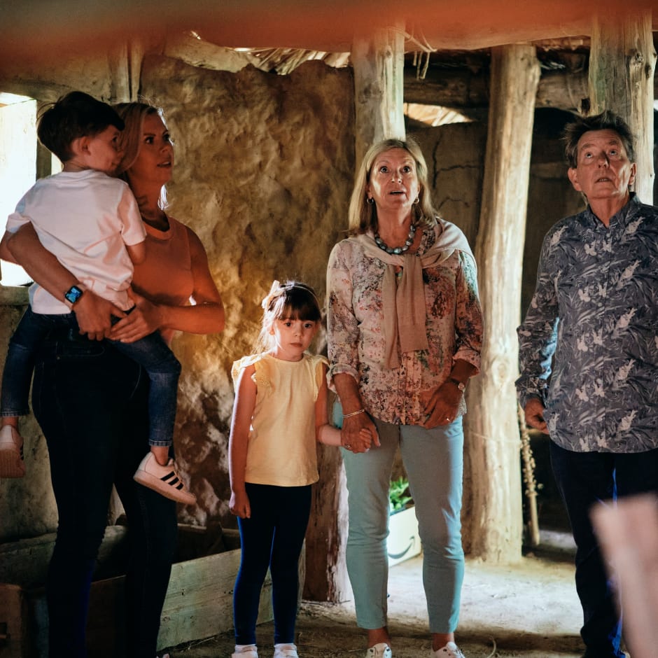 La Hougue Bie family in Longhouse with volunteer