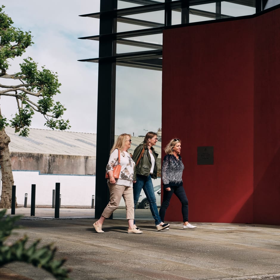 rsey Archive three women walk into main entrance area