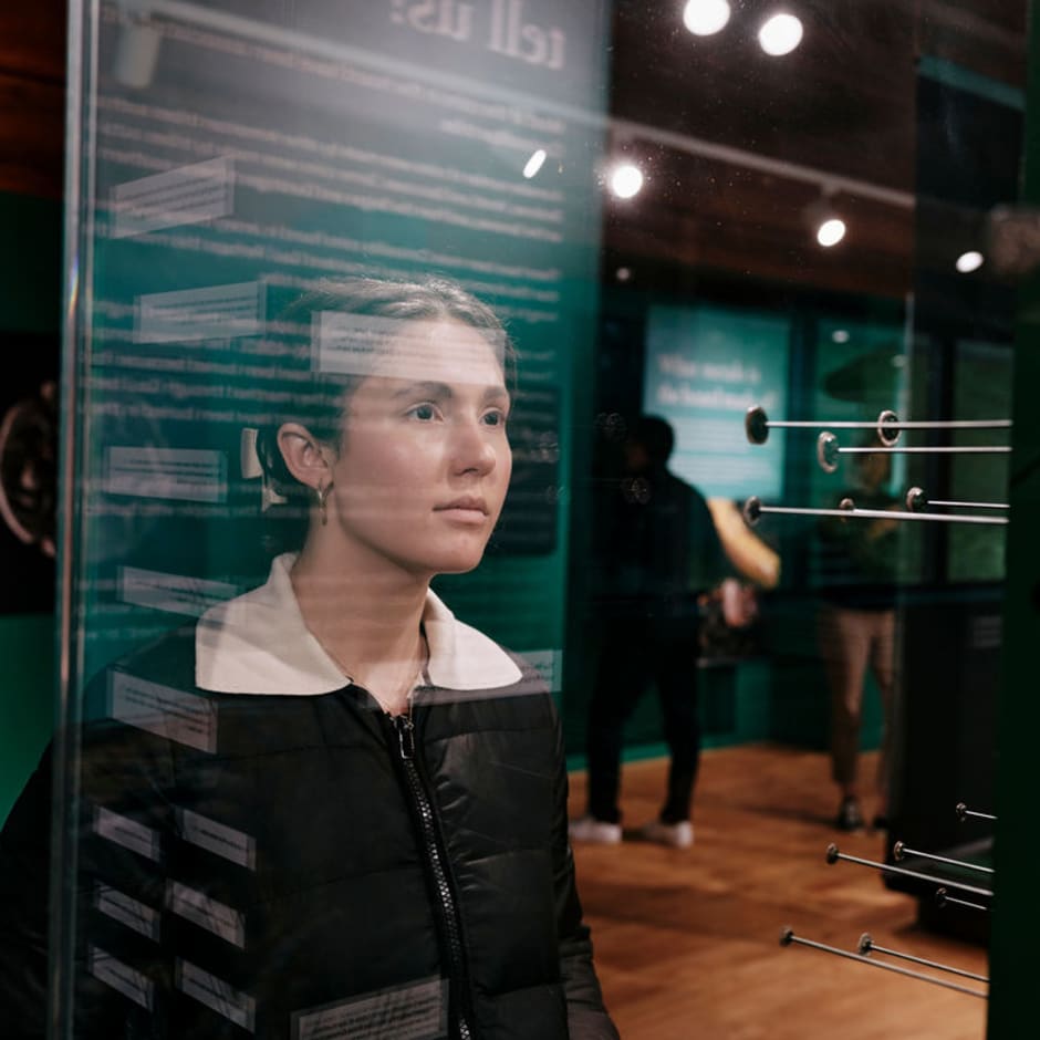 Young women looks closely at a display case