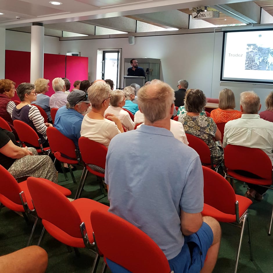 People sit and listen to a presentation