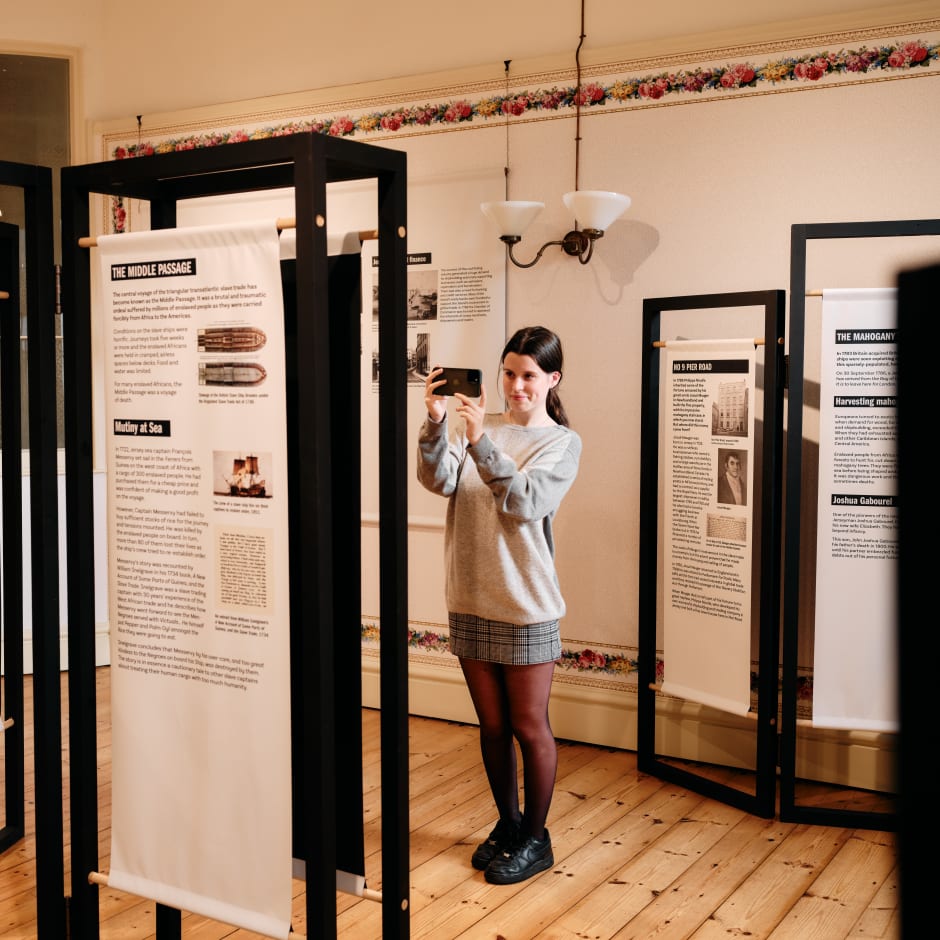 Person takes a photo of an exhibition panel