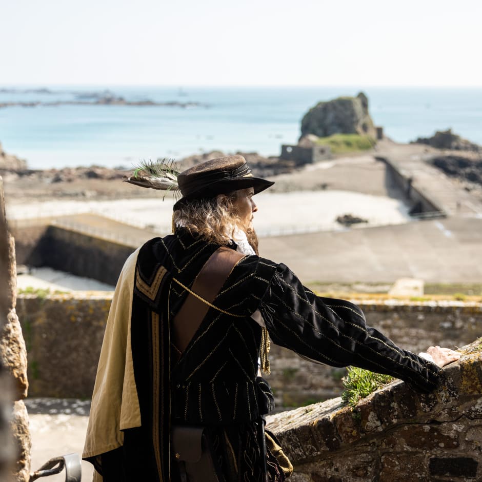 person dressed in a Elizabethan costume looks at a view
