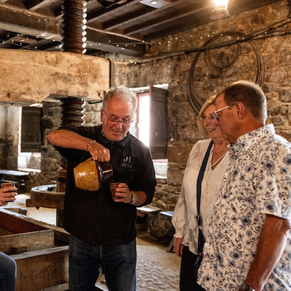 four people tasting cider