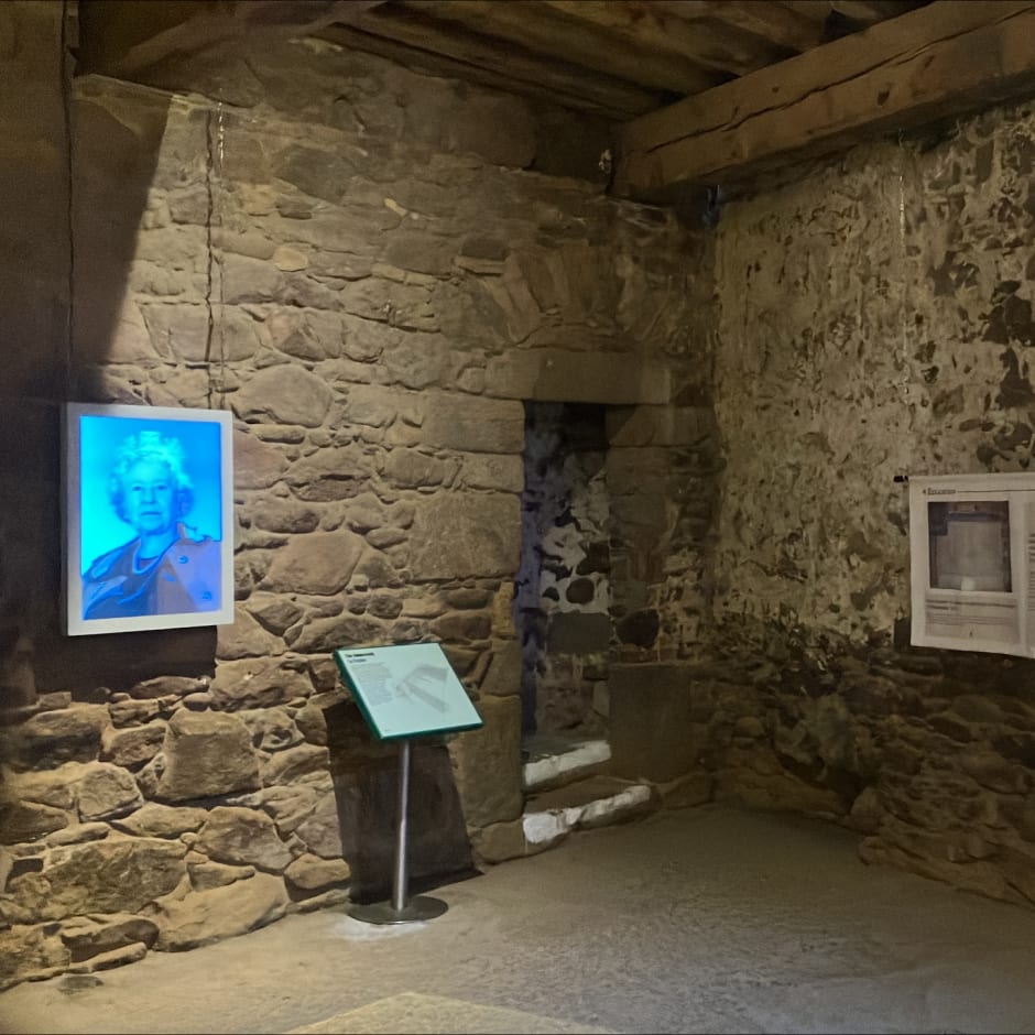 exhibition hangs on stone wall