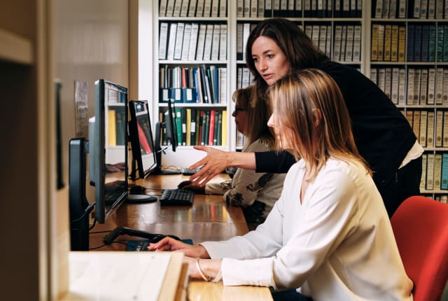 Jersey Archive Member of staff helps person on computer