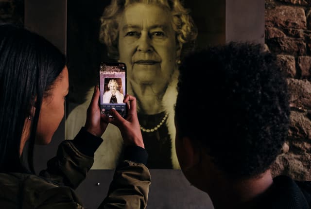 Mont Orgueil Castle children take picture of Queen Elizabeth II portrait