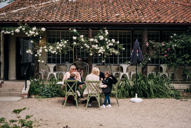 Family sit at picnic bench