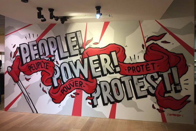 Sign reads People Power Protest in Graffiti