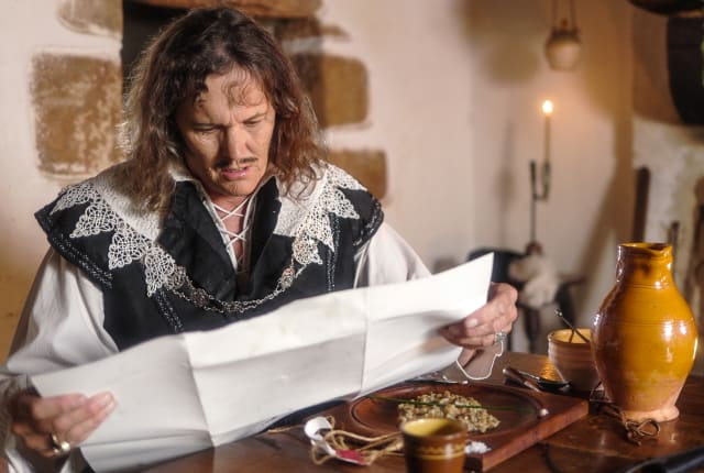 Living History Character reads scroll
