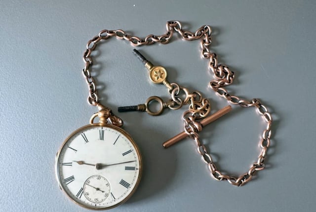 A silver pocket watch and chain