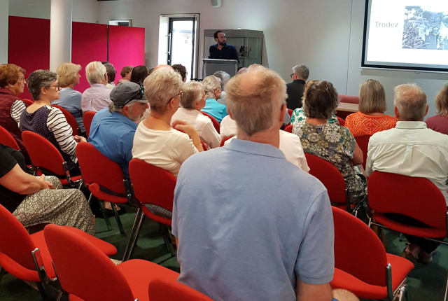 People sit and listen to a presentation