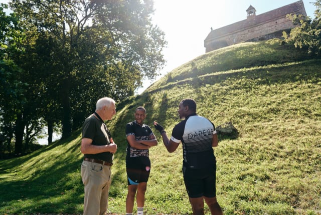 Two visitors talk to a guide