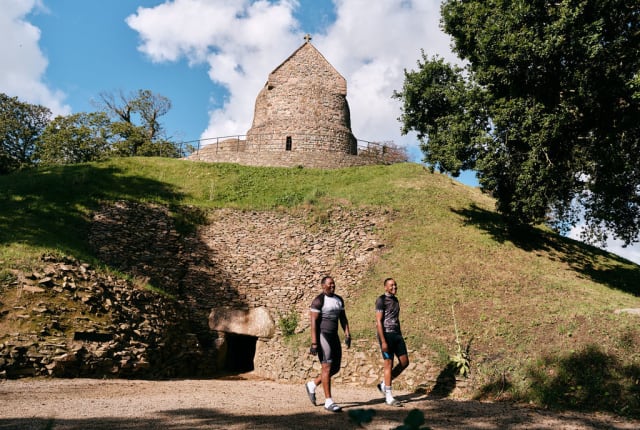 Two visitors walk at an ancient site