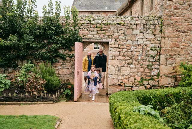 Family walk through pink door