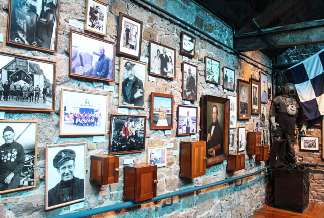 A wall with lots of framed photographs