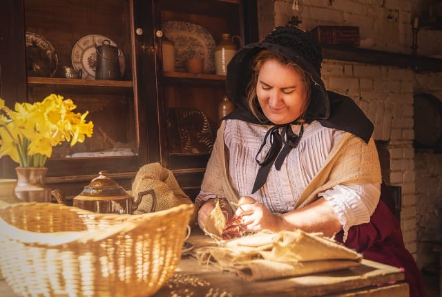 Woman sits at a country table