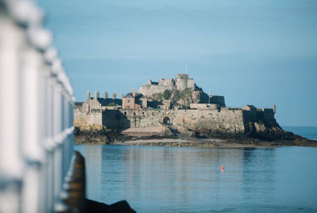 Calm sea in front of an island castle