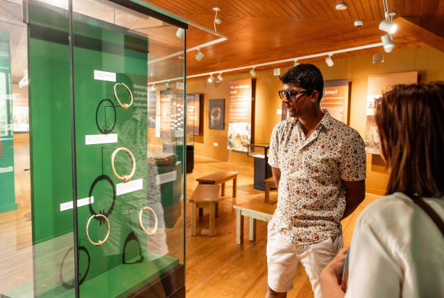 Man and women look at an exhibition case
