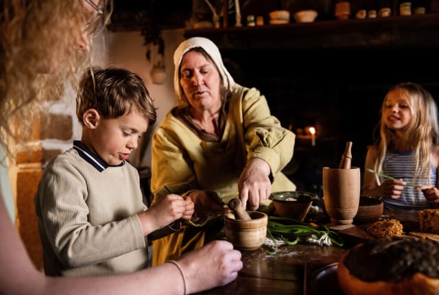 women in 17th century dress shows a pestle and morta