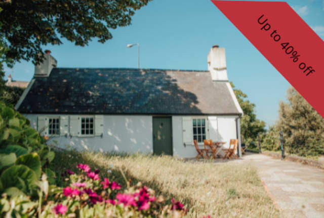 A white cottage in a garden