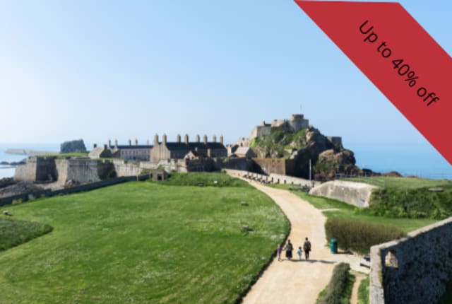 A castle with long path across a green