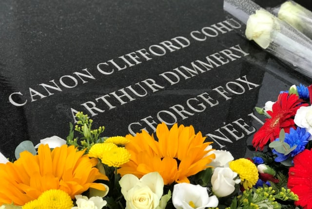 A memorial stone with fresh flowers